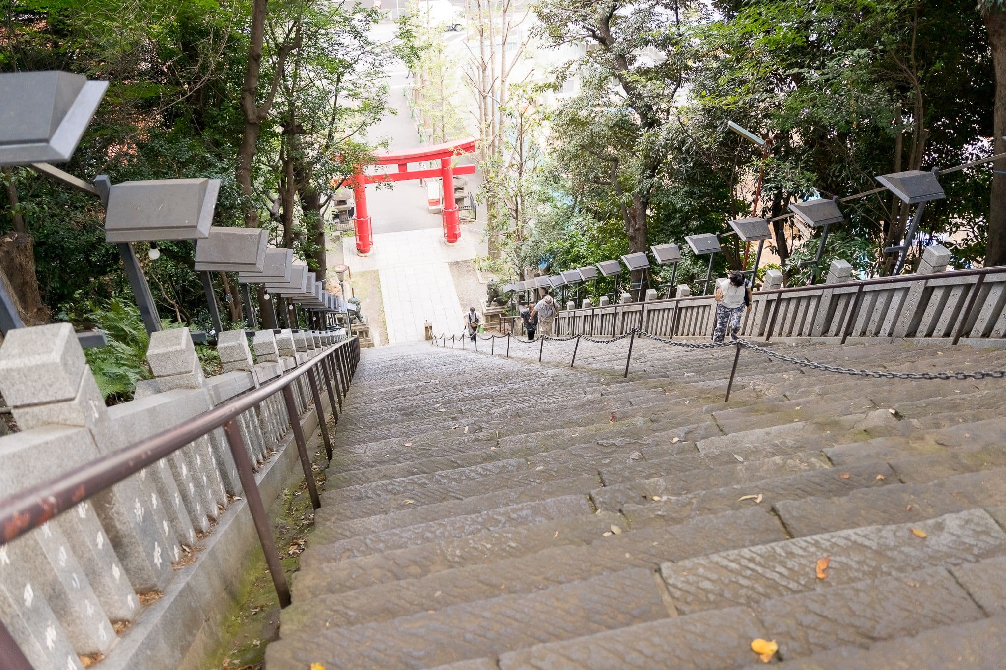 The view down the stairs from the top of Atago Shine, looking towards a large red Torii gate